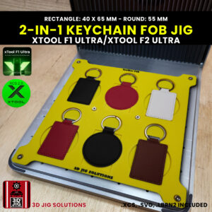 A top-down view of the xTool F1 Ultra Leather Keychain Jig holding both round (55mm) and rectangular (40x65mm) blank leather key fobs.