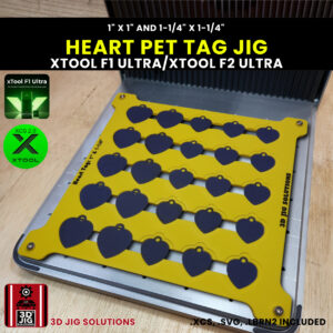 xTool F1 Ultra laser jig securely holding heart-shaped pet tags with an xTool F1 Ultra laser nearby.