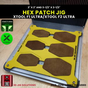 A top-down view of the xTool F1 Ultra Hex Patch Jig loaded with blank 3" x 2" and 3.5" x 2.5" hexagonal leatherette patches.