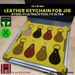 A top-down view of the xTool F1 Ultra Leather Keychain Jig loaded with multiple blank PU leather key fobs