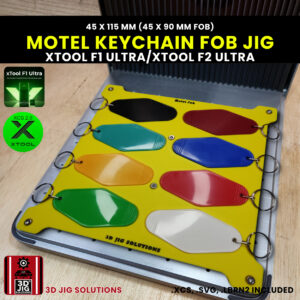 A top-down view of the xTool F1 Ultra Motel Key Fob Jig loaded with sample retro 45x115 mm} key fobs.