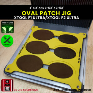 A top-down view of the xTool F1 Ultra Oval Patch Jig loaded with blank 3" x 2" and 3.5" x 2.5" oval leatherette patches.