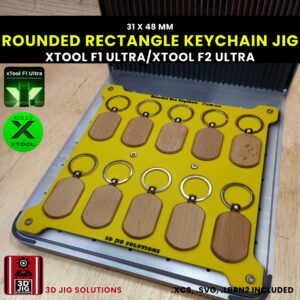 A top-down view of the xTool F1 Ultra Oval Keychain Jig holding 10 blank 31x48mm rounded rectangle bamboo keychains.