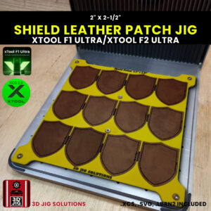 A top-down view of the xTool F1 Ultra Shield Hat Patch Jig holding multiple blank shield-shaped leatherette patches.