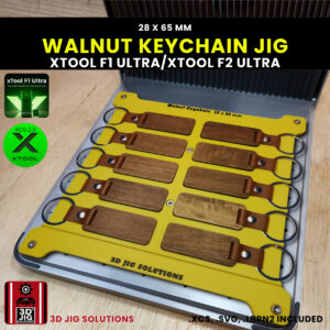 A top-down view of the xTool F1 Ultra Rectangle Keychain Jig loaded with 10 blank walnut wood keychains