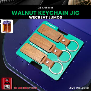 A top-down view of the WeCreat Lumos keychain jig holding three 28x65mm rectangle walnut keychains.