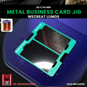 A top-down view of the WeCreat Lumos business card jig holding two blank metal business cards.